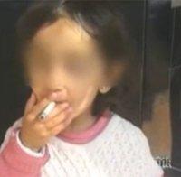 Вижте кой поощрява 3-годишното дете от скандалния клип да пуши (видео)